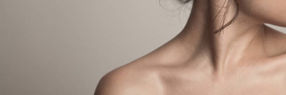 A closeup of a profile of a young woman with long dark wet hair